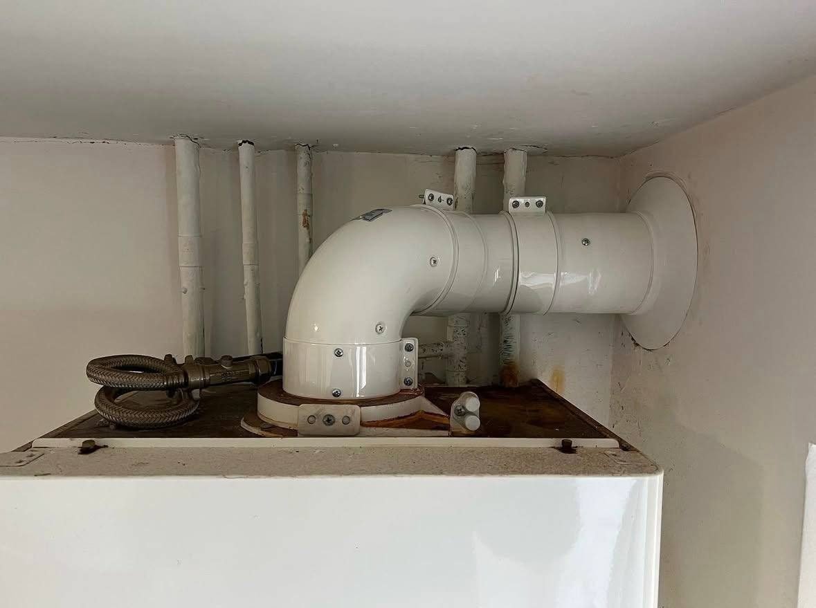 New flue run and terminal fitted above a replacement boiler